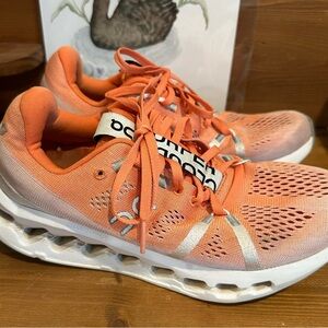 On Cloudsurfer Woman’s Flame Orange and white shoes